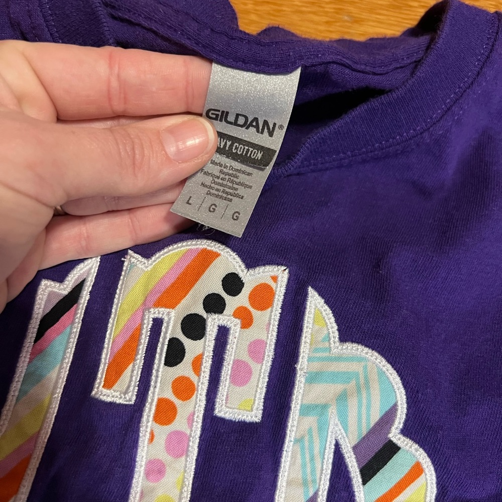 Purple T-shirt, initials ‘nTd’